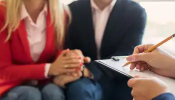 Husband And Wife Supporting Each Other At Couple's Therapy