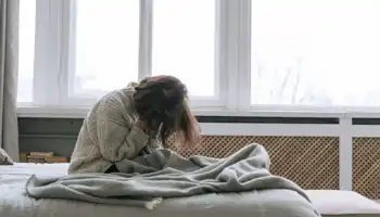 A Woman Sitting On A Bed (1)