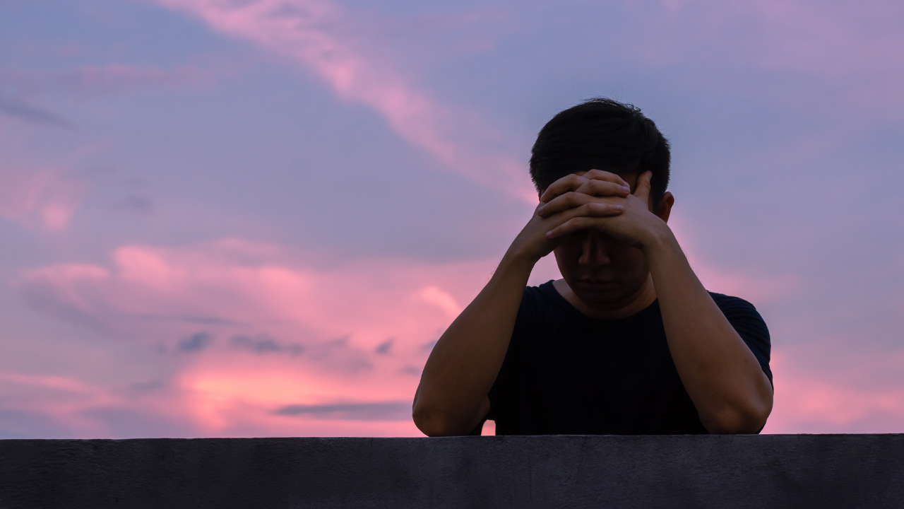 Stressed Man Looking Over Horizon With Dark Skies