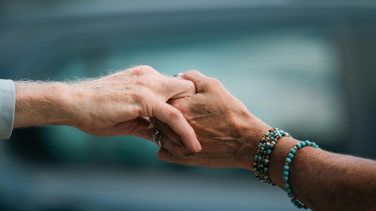 Close Up Of Elderly Hands Holding In Comfort