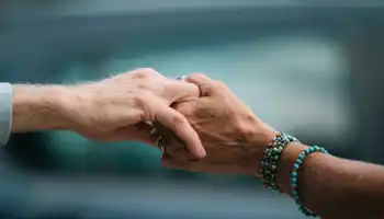 Close Up Of Elderly Hands Holding In Comfort