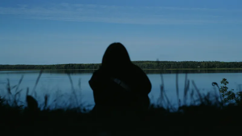 Person Sitting Near Lake
