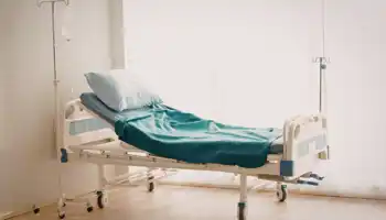 Empty Hospital Bed In A Clean Room
