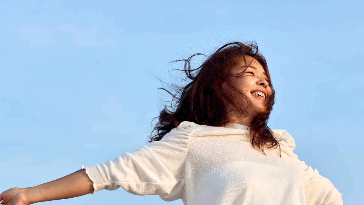 Joyful Woman Embracing The Sky