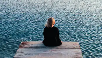 A Person Sitting Alone On Dock