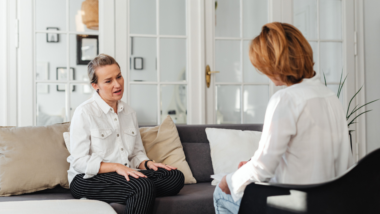 Woman In White Long Sleeves And Black Stripes Pants Talking To Woman In White Long Sleeves Top