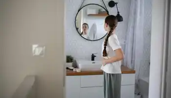 Teenager Looking At Her Body In Mirror. Body Image Concept.